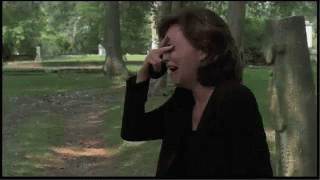 Woman Covering Face While Talking on Cell Phone