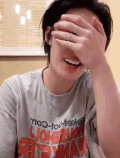 Woman Covering Face with Hand in mo-to-t9xl Shirt
