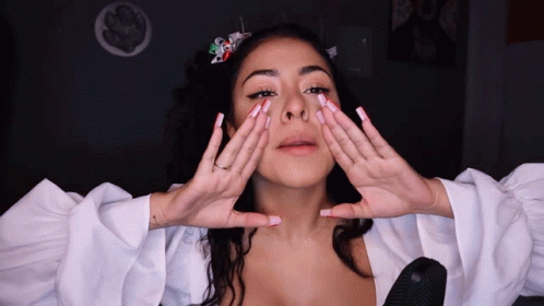 Woman Covering Face With Hands White Top