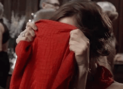 Woman Covering Face With Red Sweater