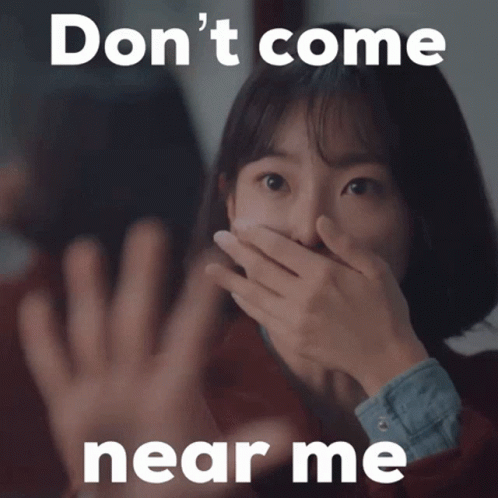Woman Covering Her Mouth Says Do Not Come Near Me GIF