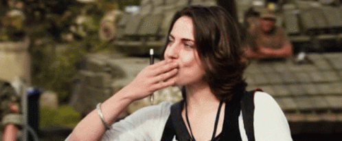 Woman Covering Mouth In Front Of Military Vehicle GIF