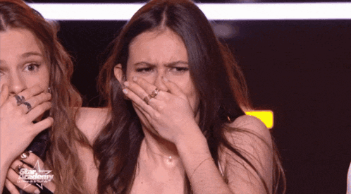 Woman Covering Mouth in Front of Star Academy Sign