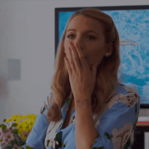 Woman Covering Mouth in Front of TV
