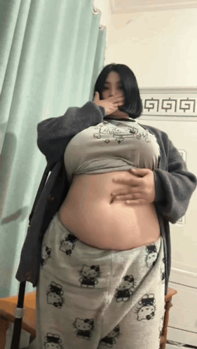 Woman Covering Mouth in Hello Kitty Shirt and Pajamas