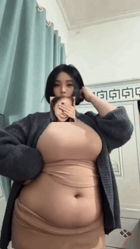 Woman Covering Mouth in Hello Kitty Shirt and Pajamas