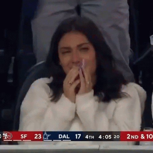 Woman Covering Mouth in Stadium