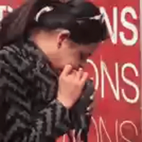 Woman Covering Mouth Near Red No Smoking Sign