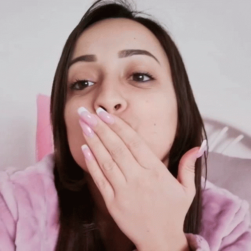 Woman Covering Mouth While Wearing Pink Robe
