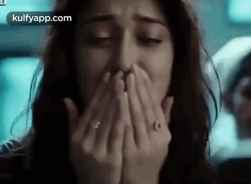 Woman Covering Mouth With Hands and Ring