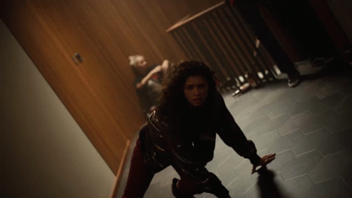 Woman Crawling on Floor in Dark Room