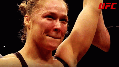 Woman Crying Holding Arm Up UFC Logo