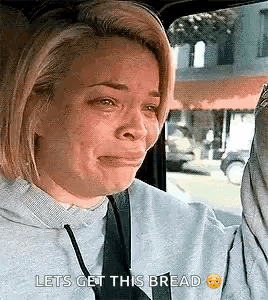 Woman Crying in Car Holding Bread