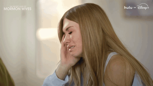 Woman Crying in Front of Hulu Sign
