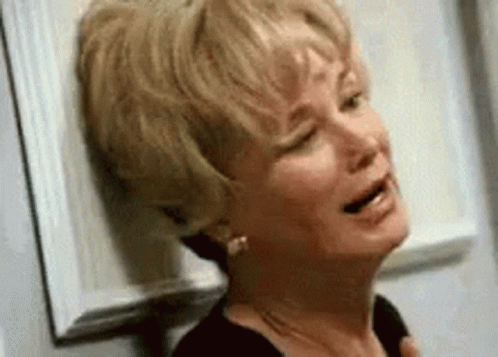Woman Crying Leaning Against Wall With Eyes Closed