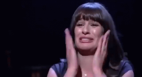 Woman Crying on Stage With Hands Folded