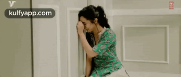 Woman Crying With Head in Hands on Bed