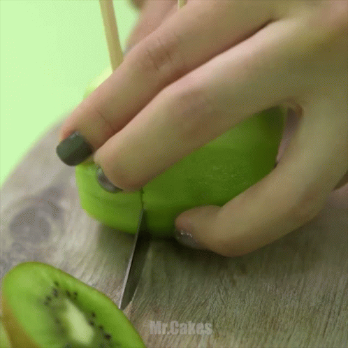 Woman Cutting Kiwi with Knife Mr. Cakes