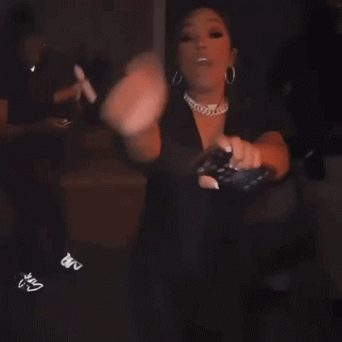 Woman Dancing in Dark Room Holding Cell Phone