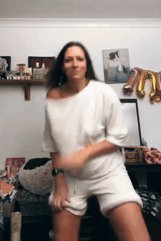 Woman Dancing in Front of Bitch Sign