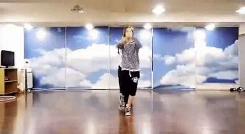 Woman Dancing in Front of Cloud Wall