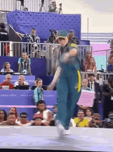 Woman Dancing In Front Of Crowd With Paris 2024 Sign GIF