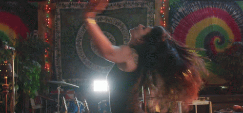 Woman Dancing in Front of I Love You Tapestry