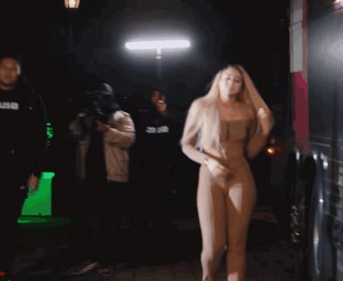 Woman Dancing in Front of Man in SNB Hoodie