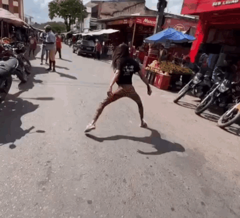 Woman Dancing in Front of Motorcycles
