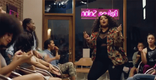 Woman Dancing in Front of Neon Sign Saying ndb2