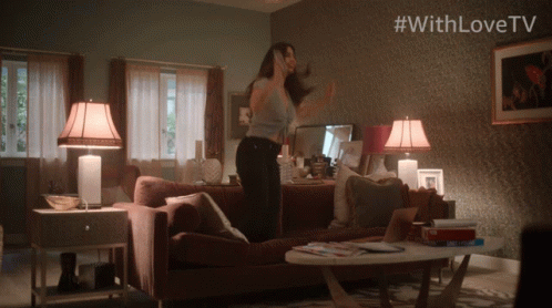 Woman Dancing In Living Room With #WithLoveTV On Wall GIF