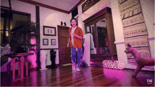 Woman Dancing In Room With Hello Sign GIF