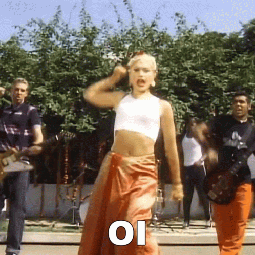 Woman Dancing in White Crop Top and Orange Skirt