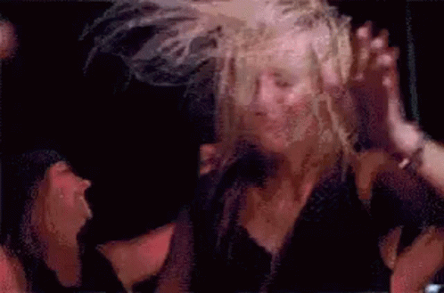Woman Dancing in Windy Crowd