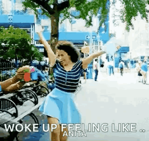 Woman Dancing with Arms Up Man Holding Drink