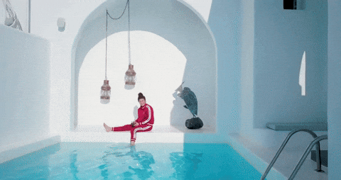 Woman Dipping Foot In Santorini Pool In Greece GIF