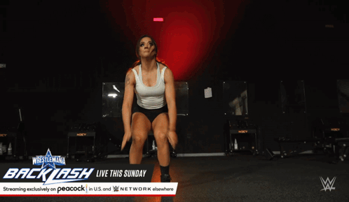 Woman Doing Push Ups in Front of Backlash Sign