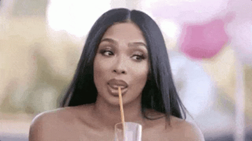 Woman Drinking from Glass with Straw