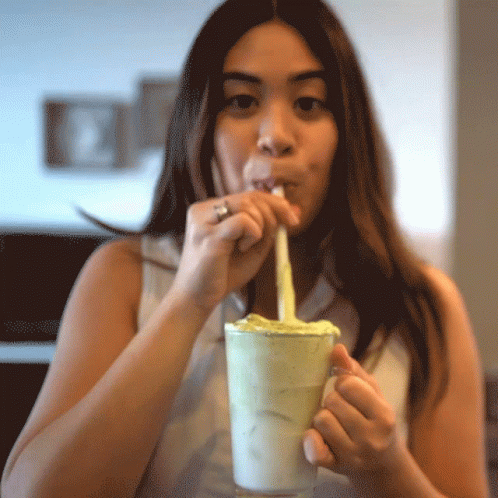 Woman Drinking Milkshake Through Straw With Ring