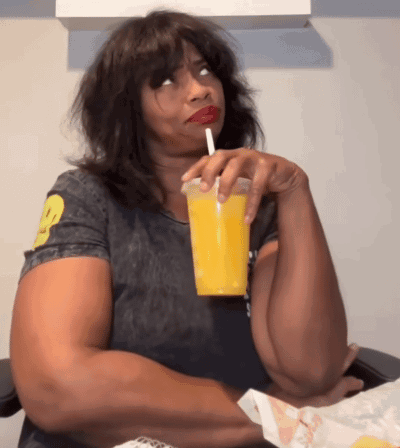 Woman Drinking Orange Juice with Straw