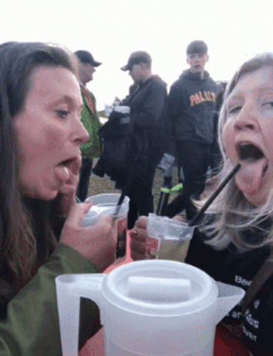 Woman Drinking Pitcher Straw Another Watching