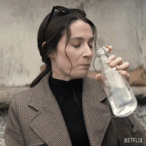 Woman Drinking Water From Bottle With Netflix Logo