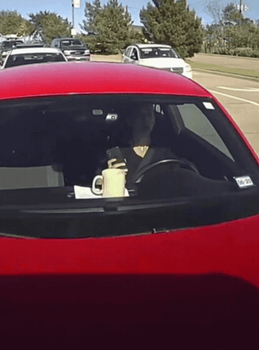 Woman Driving Red Car With Cup and NC Tag