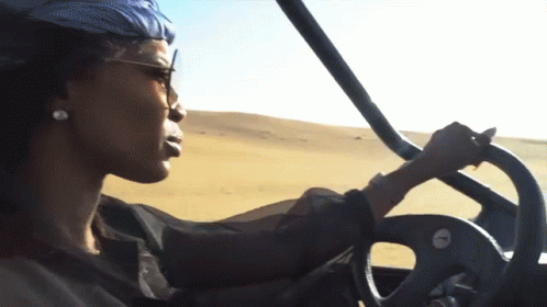 Woman Driving Vehicle in Desert