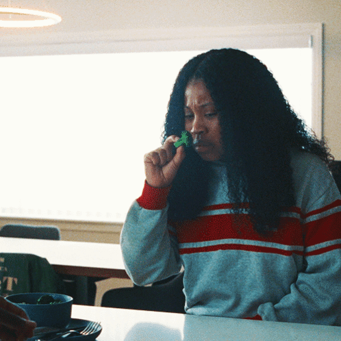 Woman Eating Broccoli At Table GIF