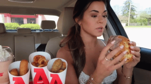 Woman Eating Burger King and Fries in Car