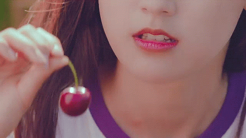Woman Eating Cherry with Green Stem