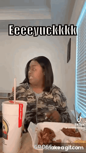 Woman Eating Chicken Wings and Drinking