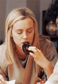 Woman Eating Donut with Another Woman
