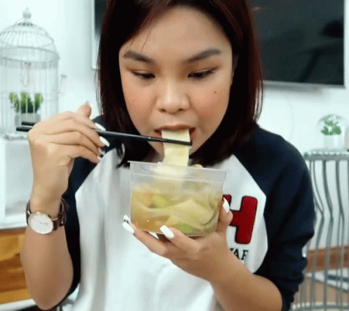 Woman Eating Food With Chopsticks GIF